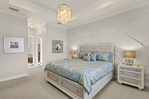 Tray ceiling, crown molding, to die for wood accent wall, mirrored closet His'N'Her walk-in closet doors combine to make a luxurious primary bedroom!