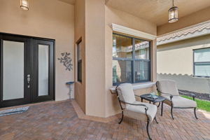 Entry door with oversized sidelight window makes for a grand entry into this fabulous home! Walkway to front door was widened! Impact resistant doors and windows throughout the home!!