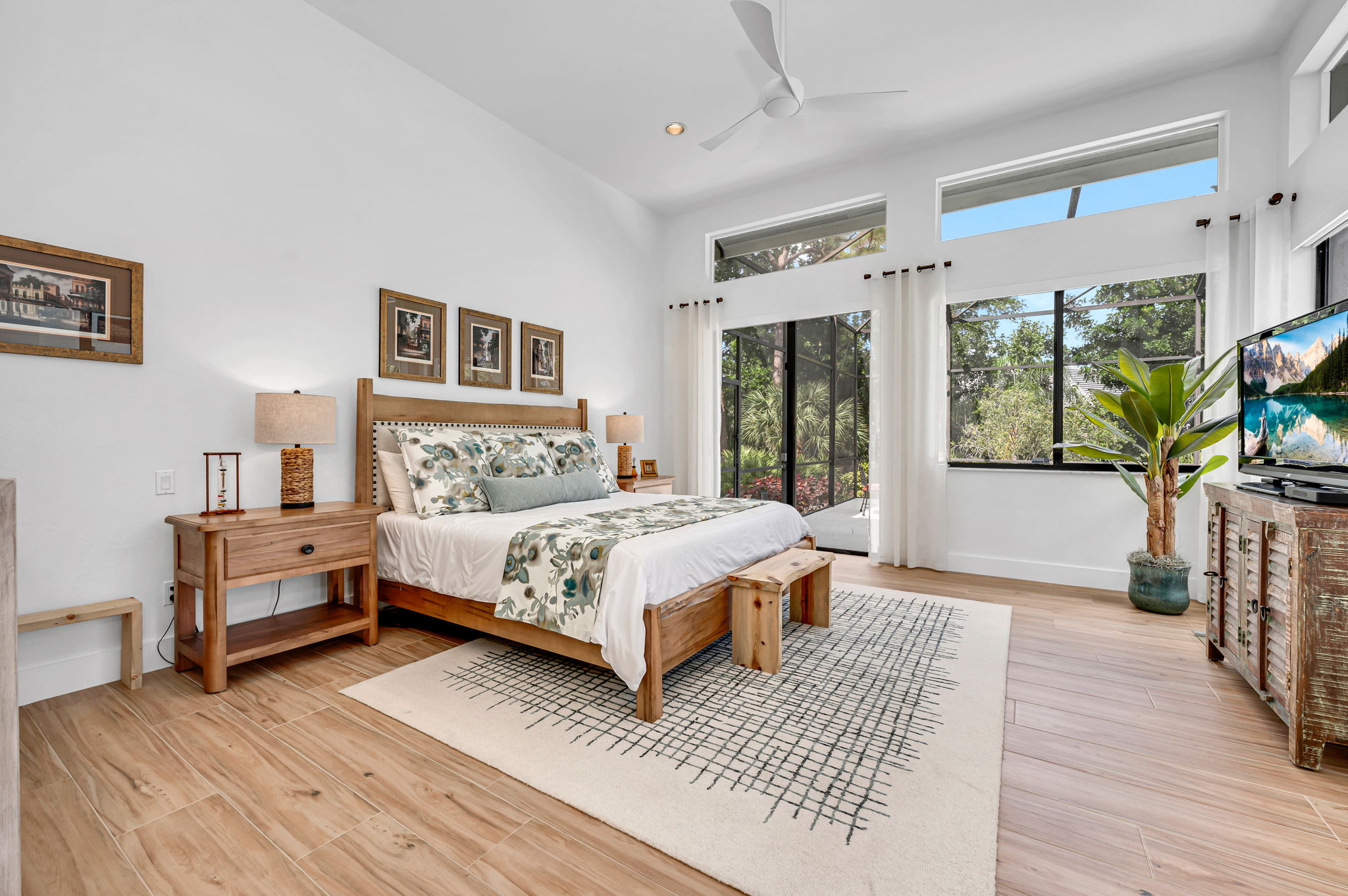 Primary Bedroom has volume ceilings, plenty of glass sliders, and large window plus transom windows above. AWWWW moment!