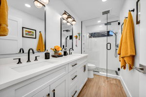 Guest Bathroom with quartz countertops, seamless glass shower door and enclosure and a touch of class!