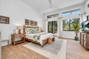 Primary Bedroom has volume ceilings, plenty of glass sliders, and large window plus transom windows above. AWWWW moment!