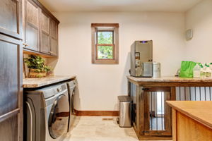 Laundry Room with Maple Cabinets and Indoor/Outdoor Dog Kennel