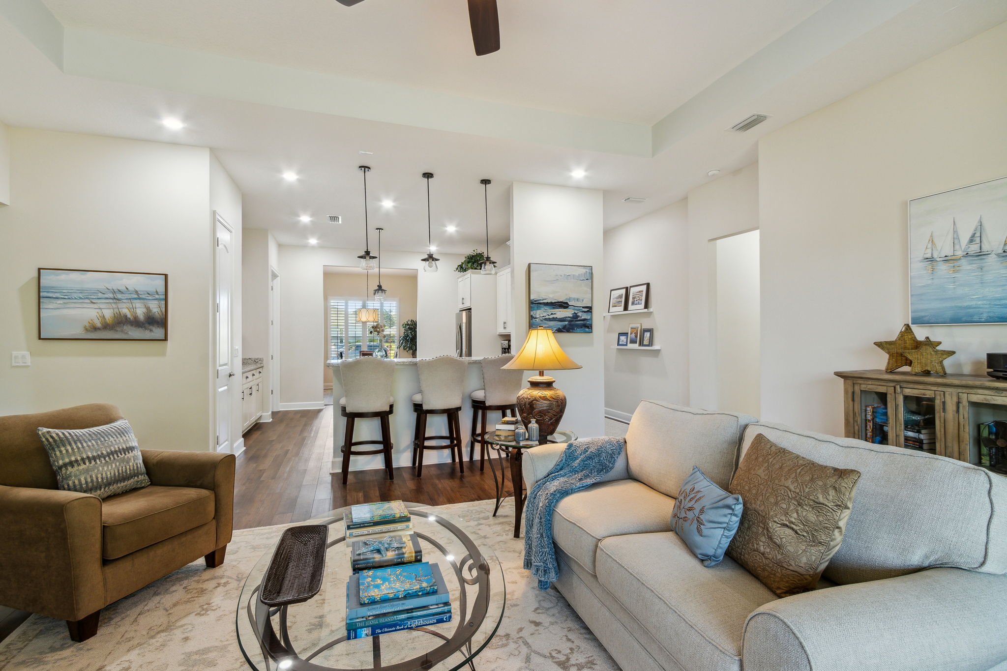 Living Room to Kitchen with Entry to Primary Suite to Right