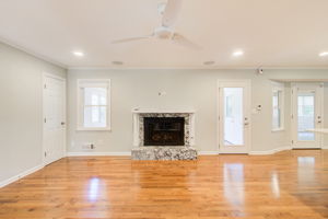 27 Living Room B Fireplace Detail w Sunroom + Sunporch Access