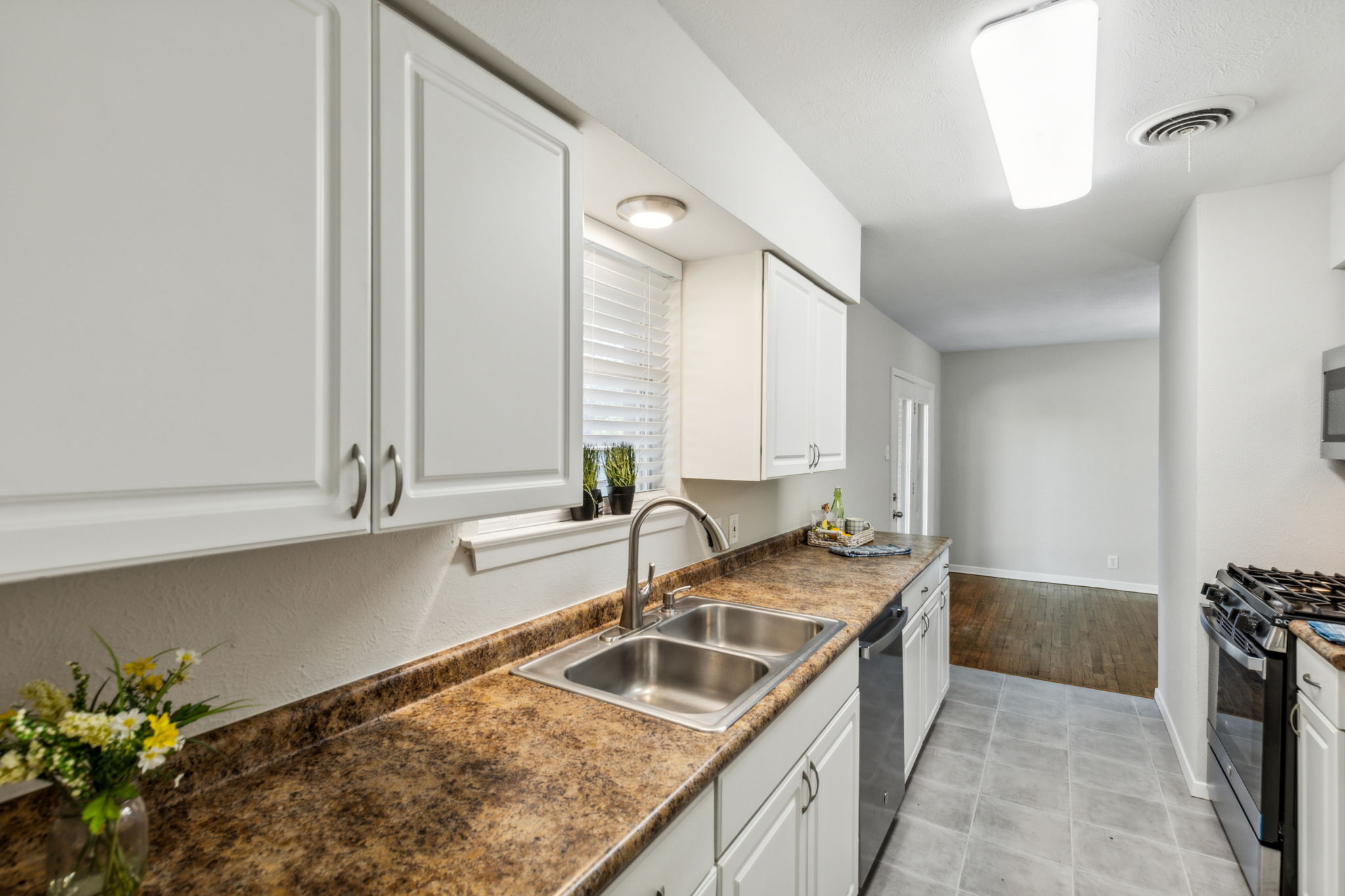 Love all the counter space - clean look of the white cabinets, NEW flooring and NEW appliances!