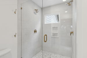 ...seamless glass shower doors with dual shower heads.