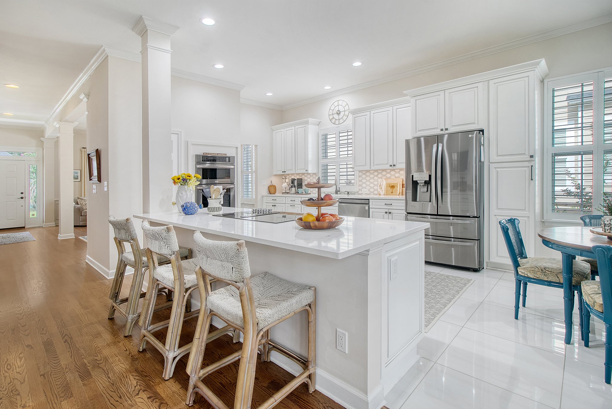 Counter height quartz counter tops in kitchen which is open to den