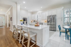 Counter height quartz counter tops in kitchen which is open to den