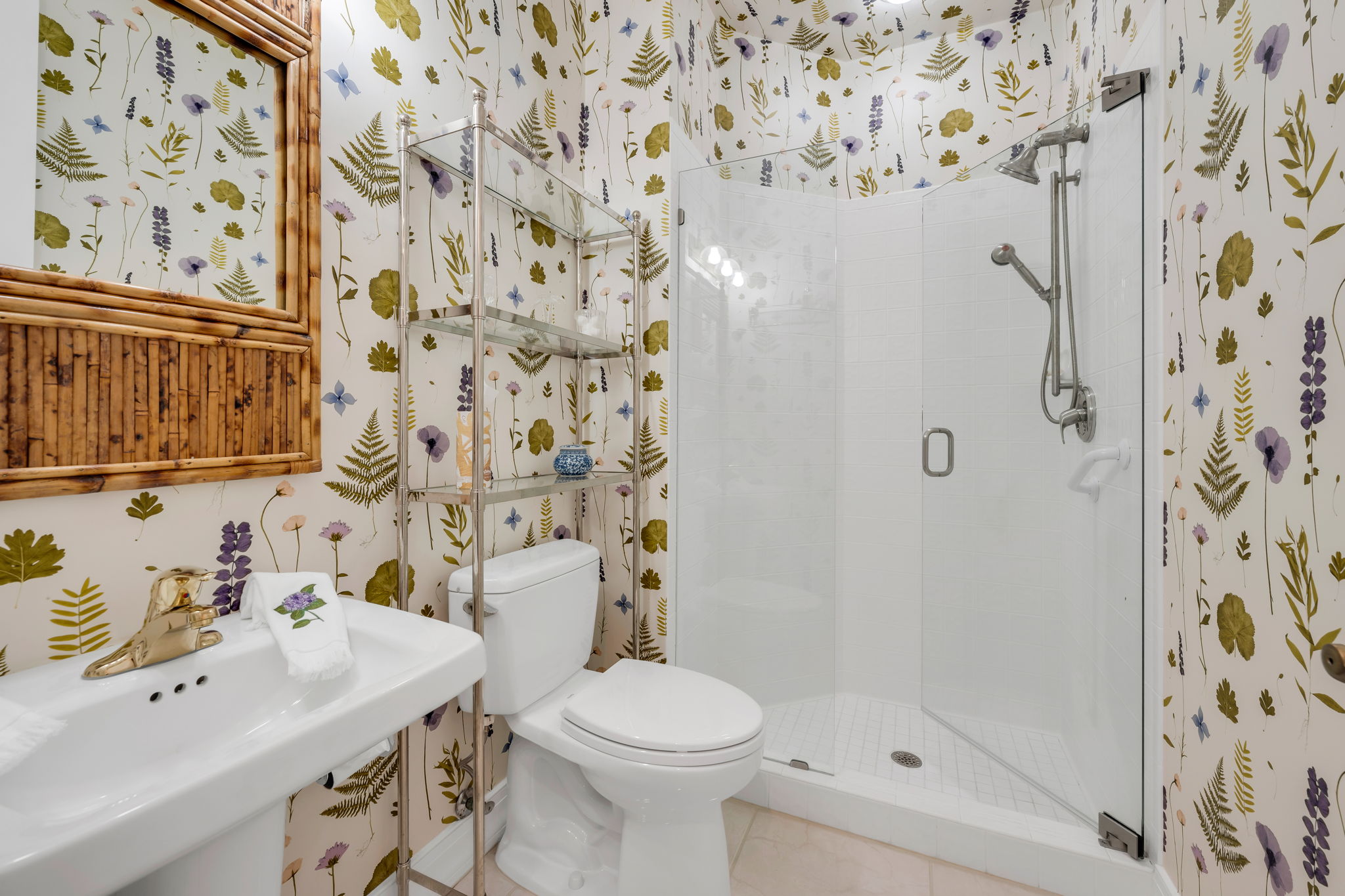 Guest Bathroom is a whimiscal delight! Updated with pedestal sink and seamless glass enclsoure.
