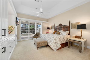 Primary Bedroom is expansive! Sliders lead to outside pool area, retractable awning for outdoor comfort