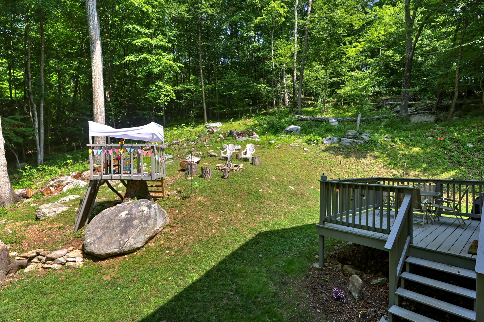 Whether roasting marshmallows, watching the kids play, or relaxing beneath the trees, this backyard invites you to enjoy every season.