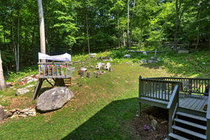 Whether roasting marshmallows, watching the kids play, or relaxing beneath the trees, this backyard invites you to enjoy every season.