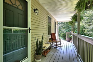 Start your day with a cup of coffee or unwind in the evening on the welcoming covered front porch.