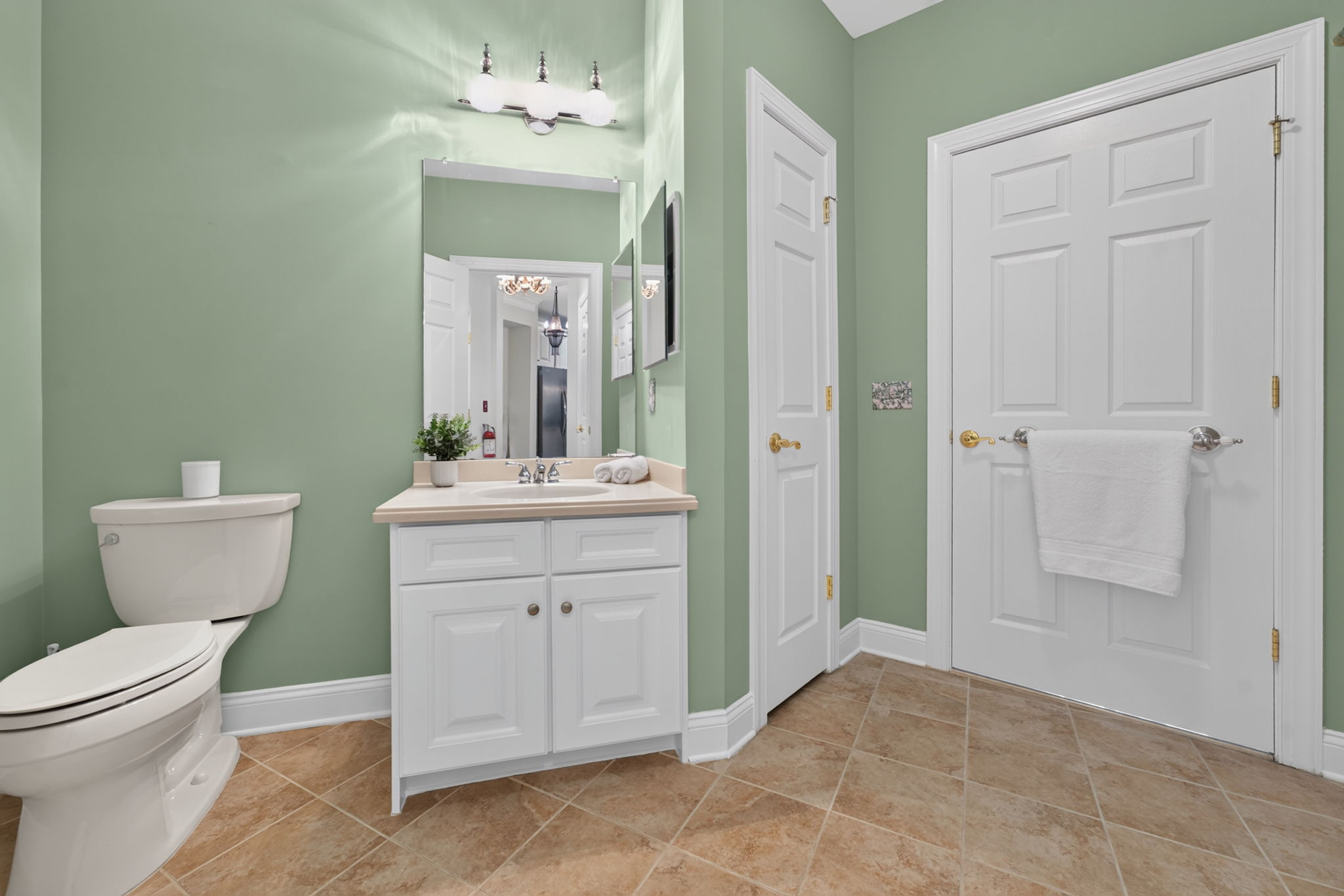 Bedroom 2 provides access to a Jack-and-Jill bath featuring a vanity, medicine cabinet, linen closet, tub-shower with a tile surround, and ceramic tile flooring.