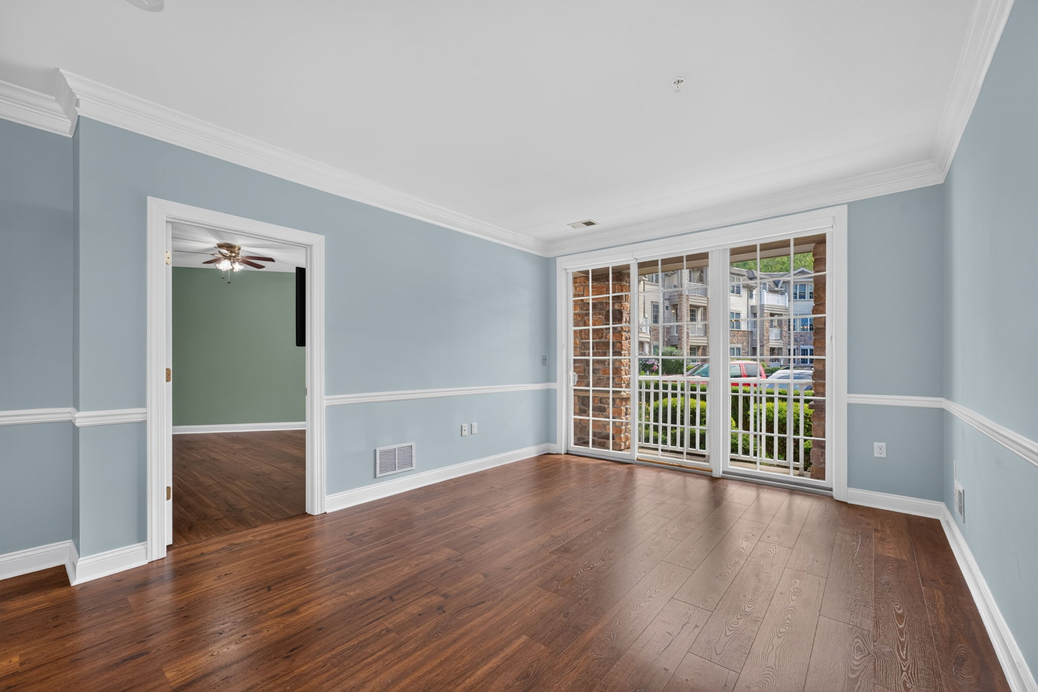 Elegant crown moldings enhance the open floor plan of the formal dining and living area. Newer LVT flooring flows seamlessly through these rooms.