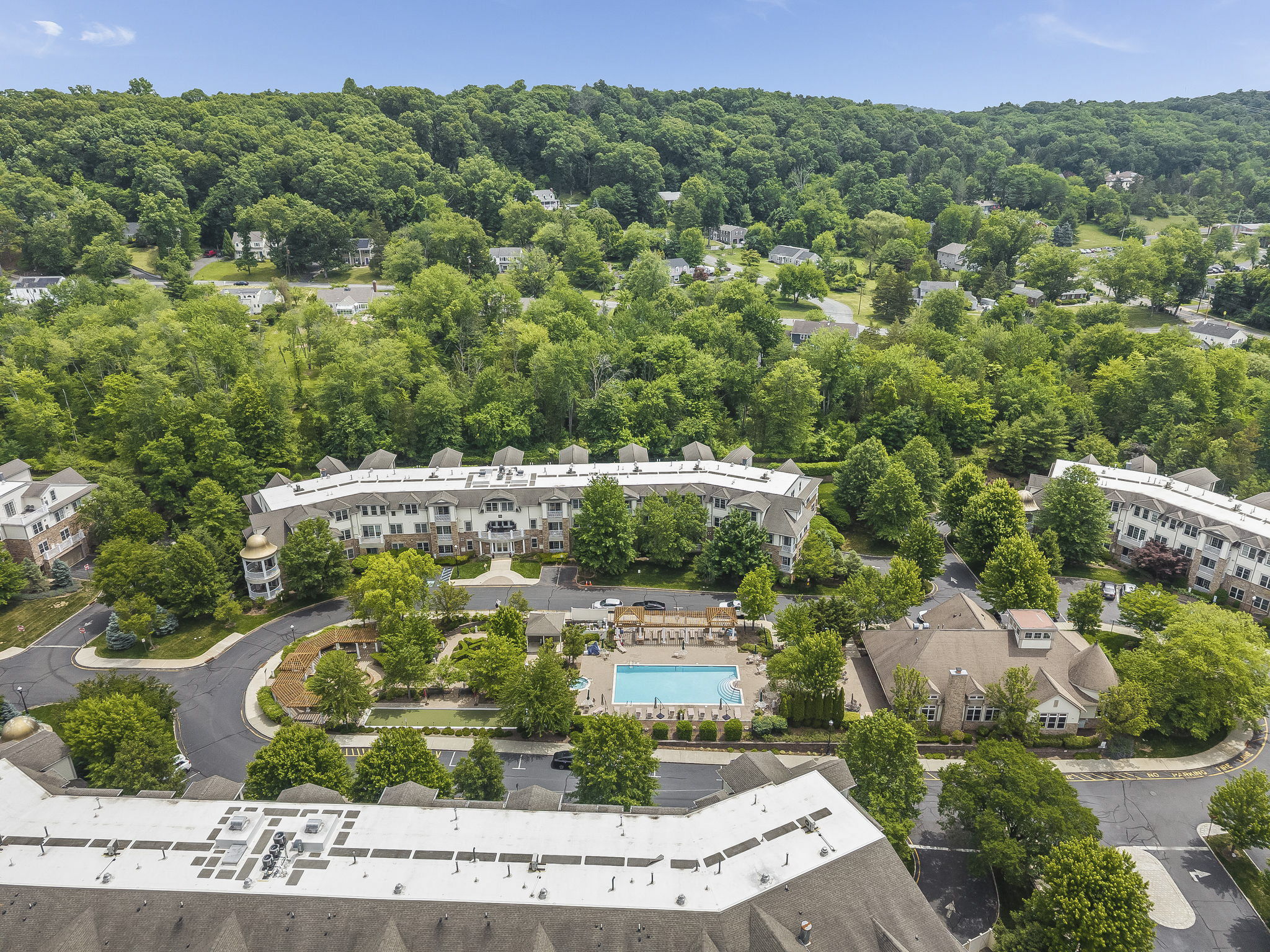 Aerial View-The meticulously maintained grounds, with colorful Zen-like gardens and a tranquil waterfall fountain creates a peaceful setting for relaxation and socializing.