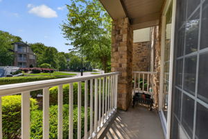 A slider from the living room opens to a charming patio, creating an ideal spot to relax or enjoy your morning coffee.