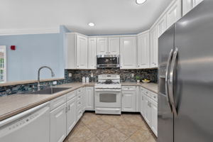 Additional kitchen enhancements include recessed lighting, candlelight fixtures, crown moulding.