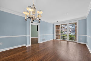 Elegant crown moldings enhance the open floor plan of the formal dining and living area. Newer LVT flooring flows seamlessly through these rooms