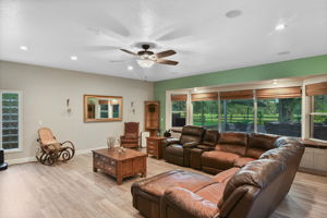 Huge living room, open to kitchen and wall of windows overlooking outdoor living area and pastures
