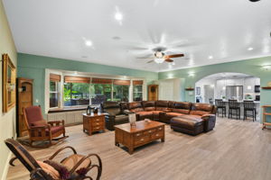 Huge living room, open to kitchen and wall of windows overlooking outdoor living area and pastures