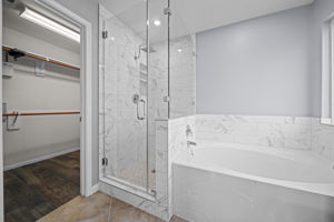 Completely updated! Soaking tub with a separate frameless shower with upgraded chic tile and a rain shower head!
