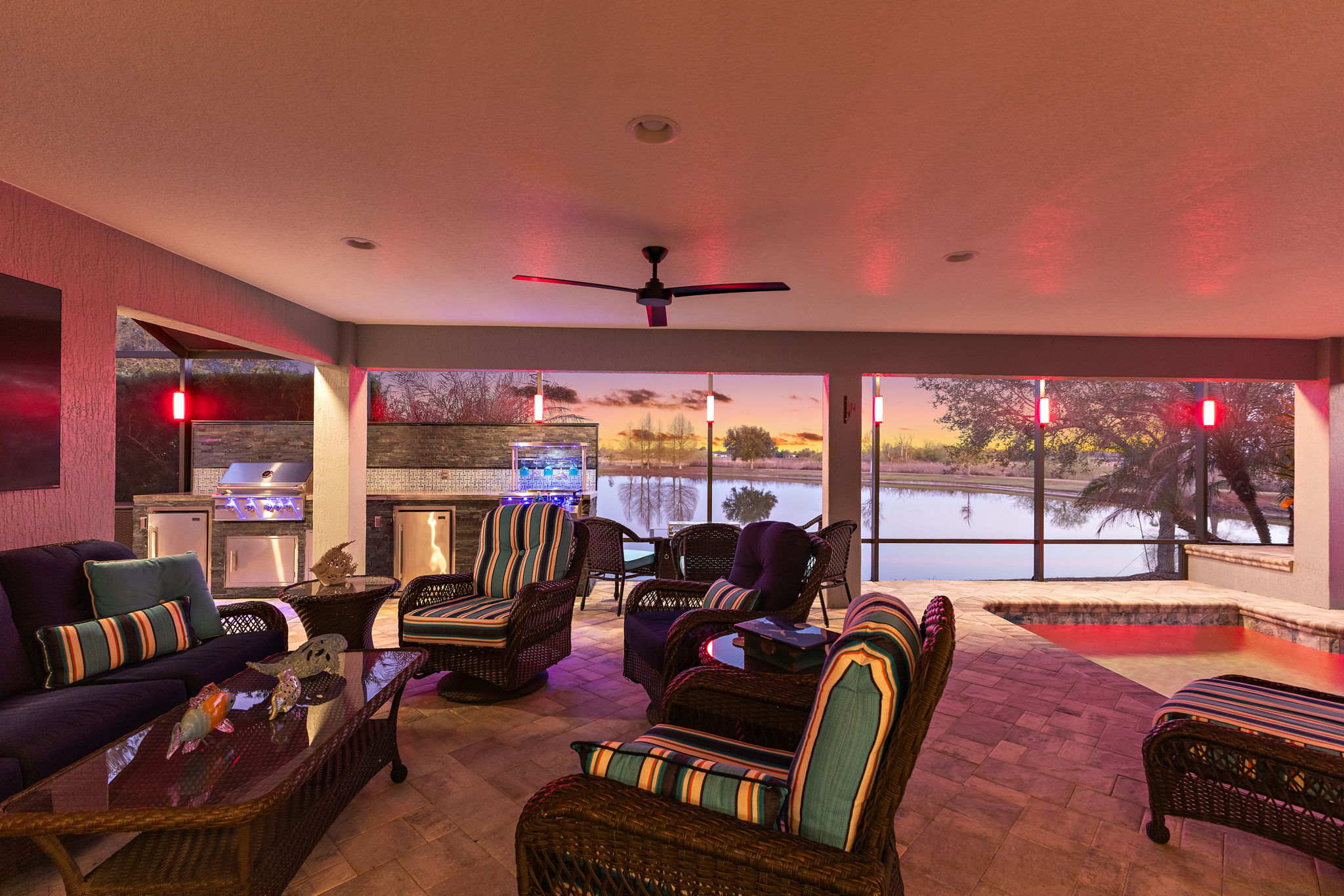 Twilight with Lanai, Swimming Pool, and Outdoor Kitchen and Bar with Water Views