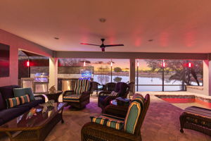 Twilight with Lanai, Swimming Pool, and Outdoor Kitchen and Bar with Water Views