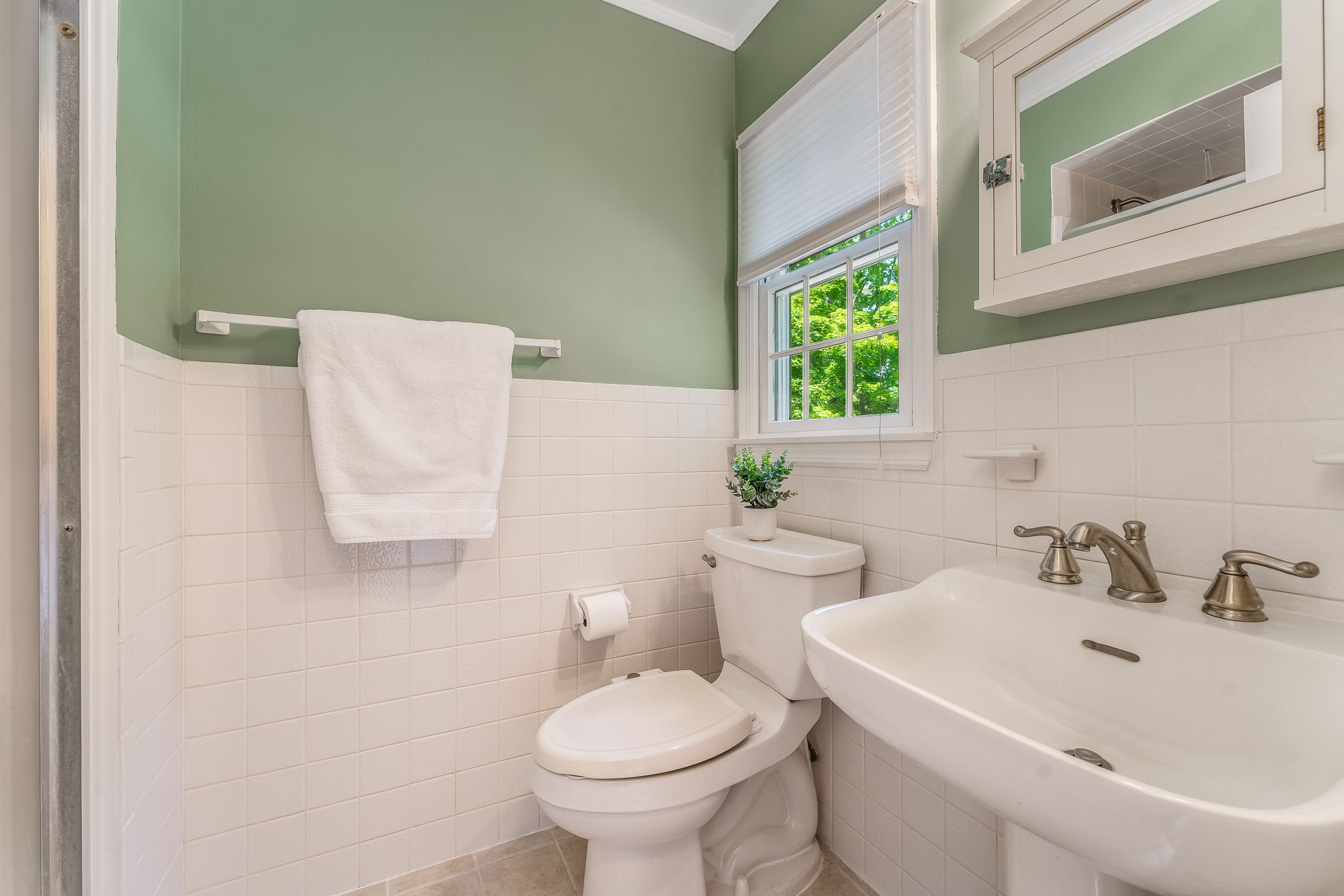Medicine cabinet with mirror, pedestal sink, shower with insert, ceramic tile floor