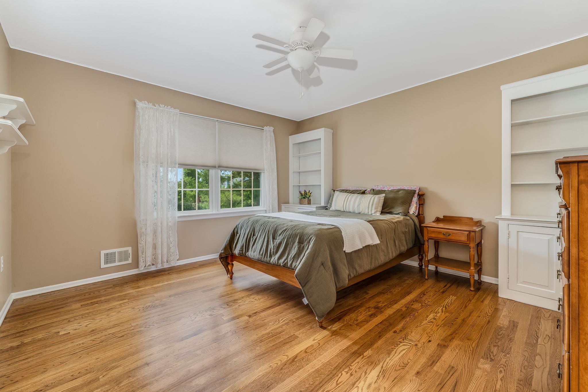 Bedroom 3 Ceiling fans 2 built-in cabinets with open shelving, double door closet and hardwood floor