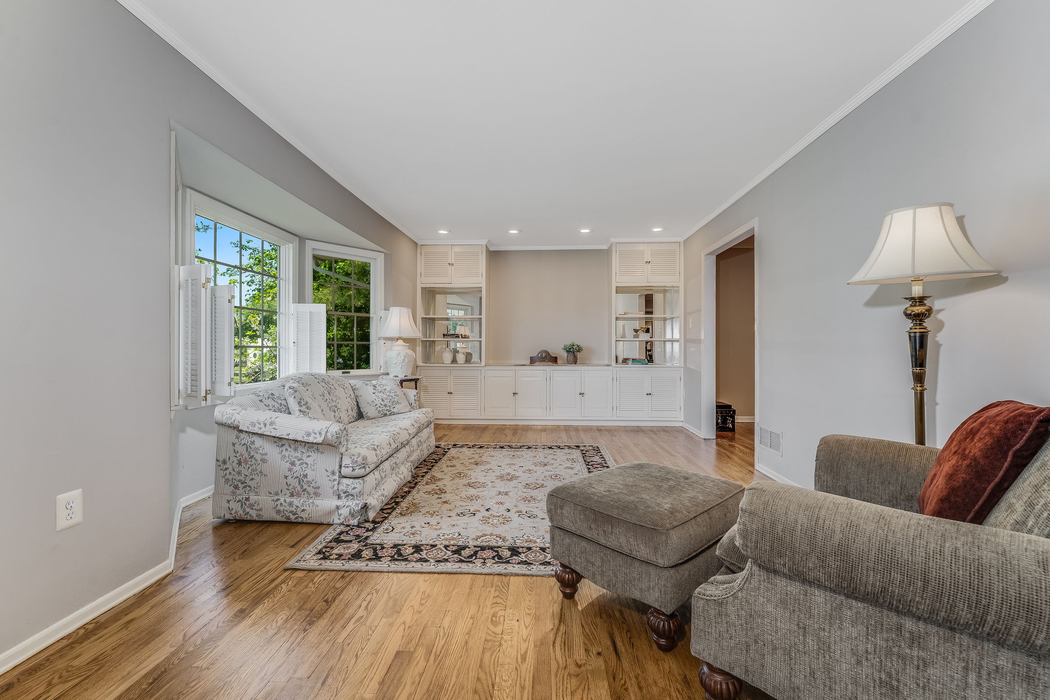 Recessed lighting, crown moulding, built-in cabinetry, bay windows, shutters, hardwood floor
