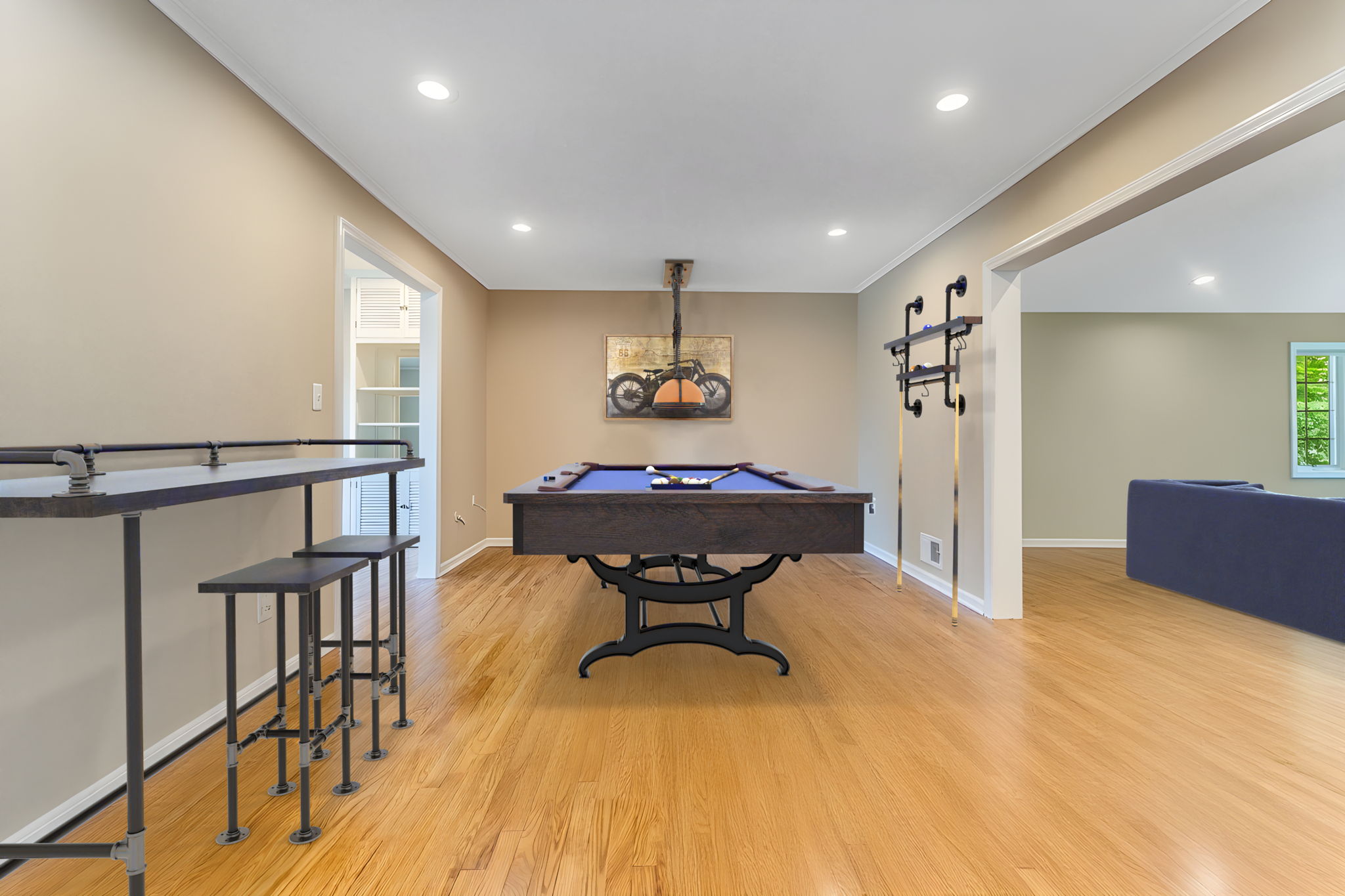 Game Room/Den-Virtually Staged- A versatile room provides the perfect space for home office/den or recreation room. Features include crown moulding, recessed lighting, hardwood floor.