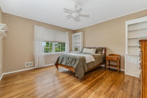Bedroom 3 Ceiling fans 2 built-in cabinets with open shelving, double door closet and hardwood floor