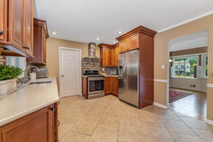 Breakfast room offers casual dining with a built-in buffet, wine fridge, and glass-front cabinetry,storing tableware within easy reach.