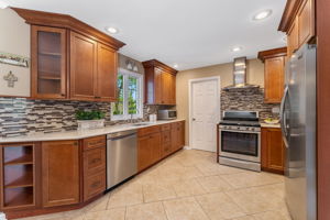 A 2017 kitchen addition features abundant maple cabinetry with soft-close feature, center island with storage, double-door pantry. Stainless steel appliances include Whirlpool 5 burner range, Broan Exhaust hood, Frigidaire Gallery Refrigerator, Whirlpool dishwasher.