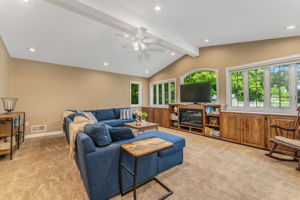 Great room addition showcases a dramatic wall of windows, volume ceiling, and custom built-ins for seamless organization.
