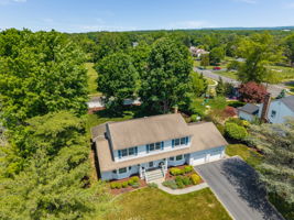 Aerial Front View-Crown and chair rail, upper cabinets, utility sink in cabinet, LG washer & dryer, ceramic tile floor. Garage and deck access.