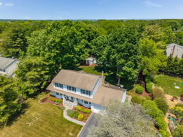 Aerial Front View-Crown and chair rail, upper cabinets, utility sink in cabinet, LG washer & dryer, ceramic tile floor. Garage and deck access.