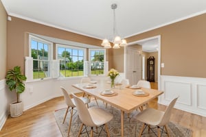 virtually staged-Crown, chairrail and picture mouldings, bay windows, shutters, Chrome and glass 5-light fixture, hardwood floor