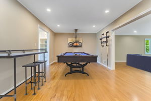 Game Room/Den-Virtually Staged- A versatile room provides the perfect space for home office/den or recreation room. Features include crown moulding, recessed lighting, hardwood floor.