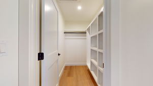 Primary bedroom walk-in closet