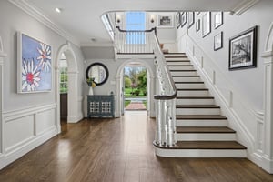 A grand entrance in every sense - sweeping staircase, exquisite millwork, and the kind of arrival moment that never gets old.