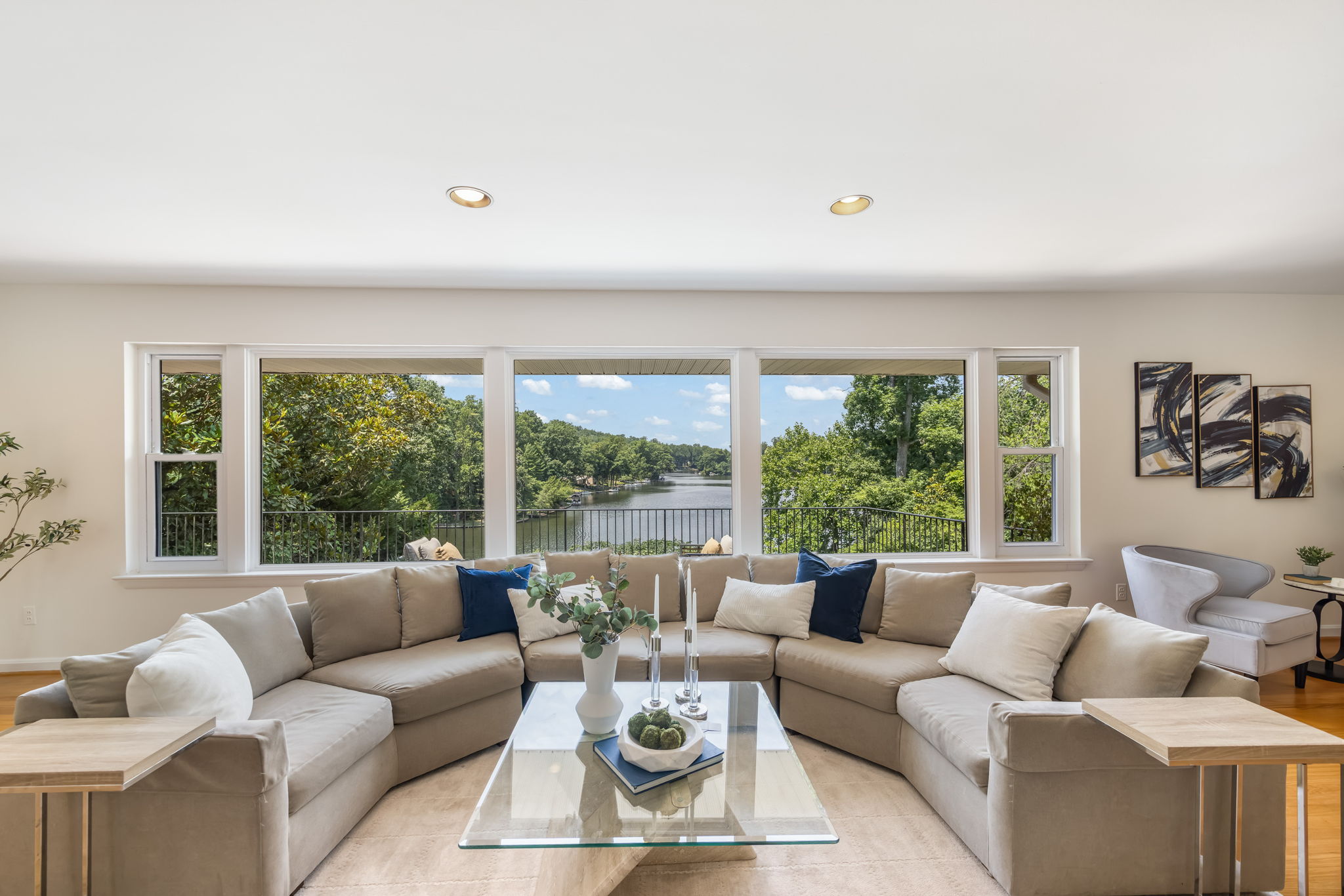 Expansive living room w/fireplace overlooks lake