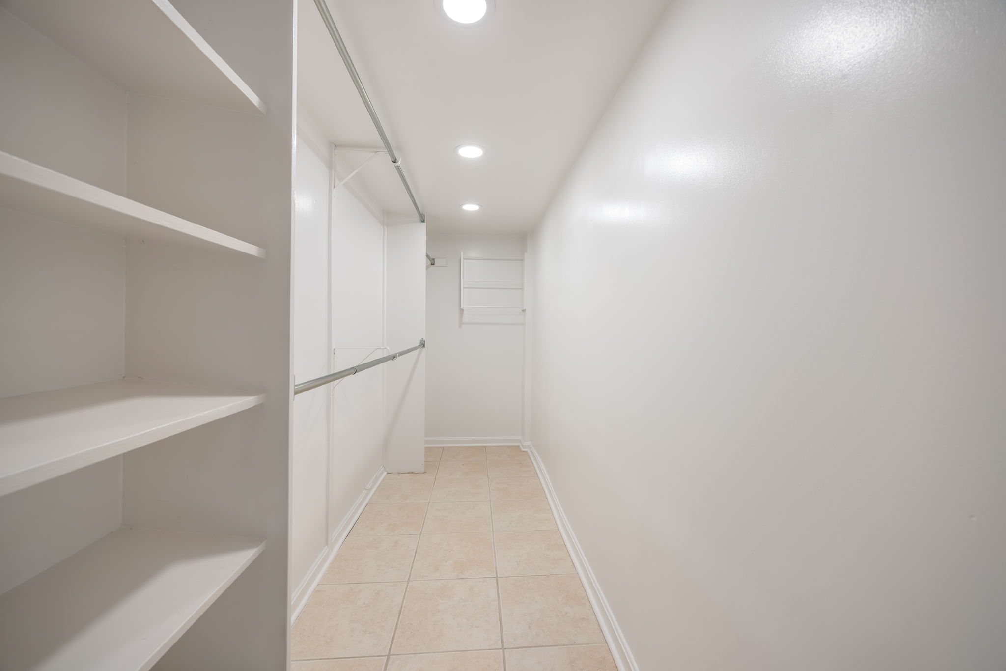 Walk-in closet in lower level primary bedroom