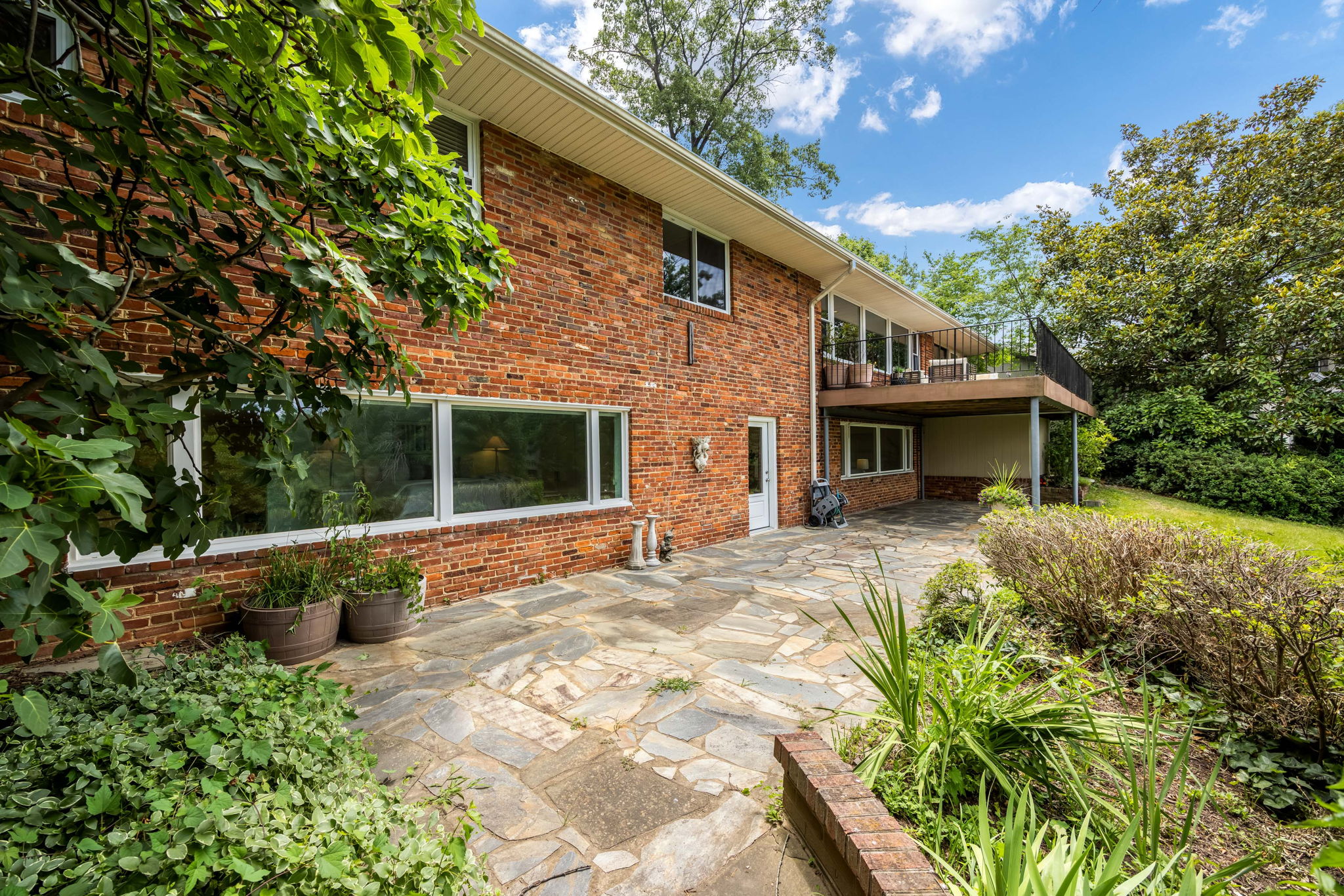 Expansive slate patio and terraced backyard