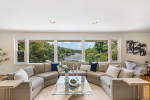 Expansive living room w/fireplace overlooks lake