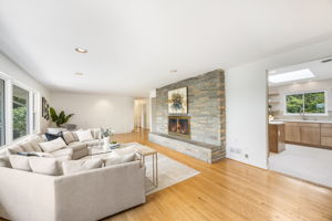 Expansive living room w/fireplace overlooks lake