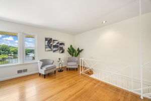 Expansive living room w/fireplace overlooks lake
