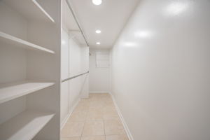 Walk-in closet in lower level primary bedroom