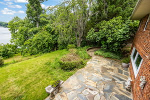 Expansive slate patio and terraced backyard